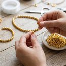 PACOTE FECHADO - Perola Com Furo Dourado 5mm 7500Un